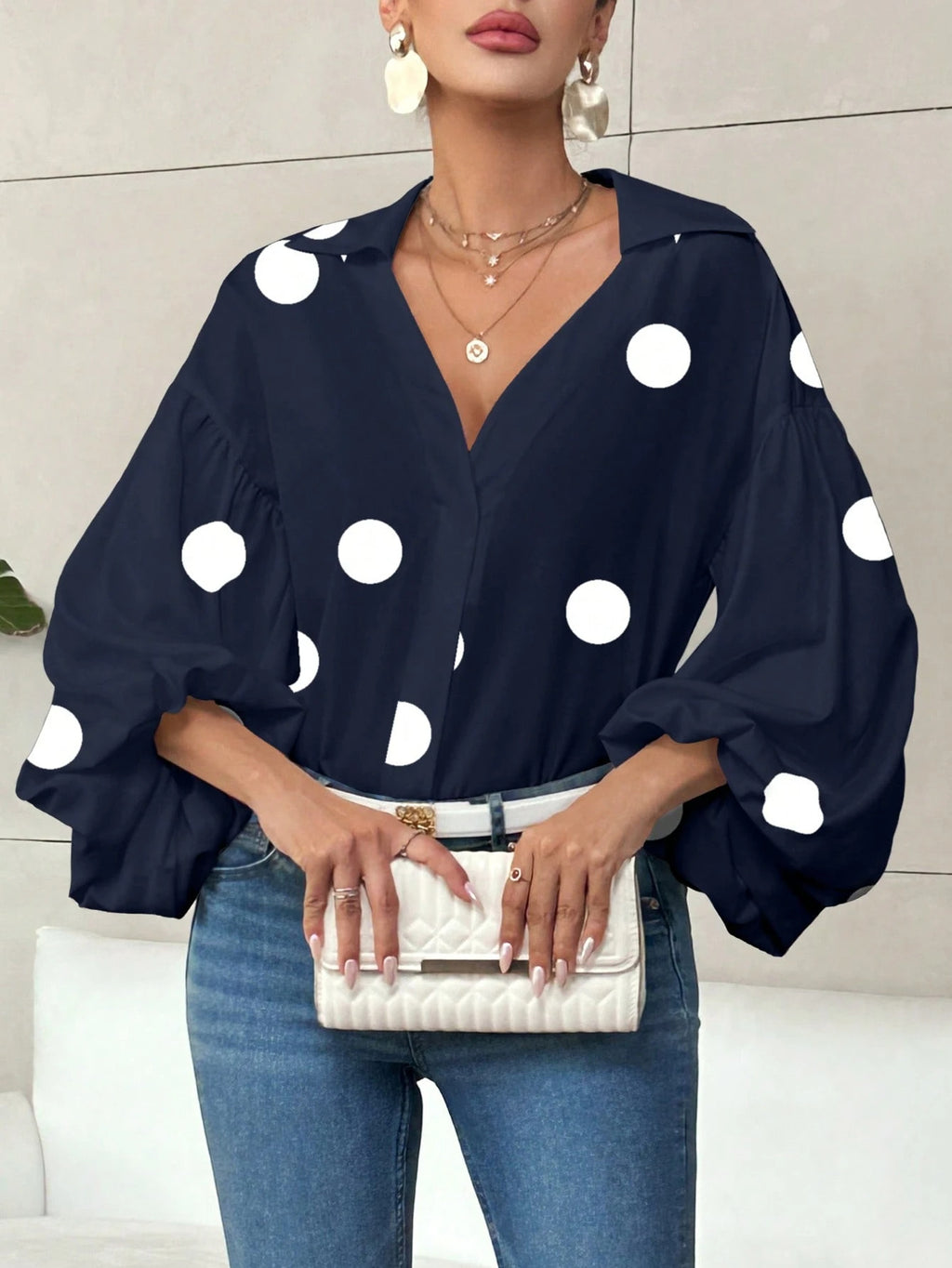 Long-sleeve polka dot top with a half-zip neck